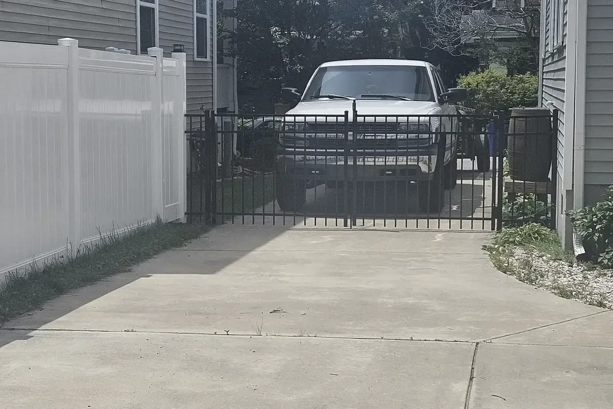Aluminum double drive gate on a concrete driveway, Chesapeake