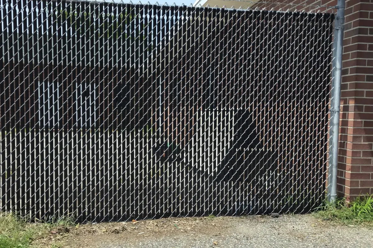 Black chain link fence with privacy slats